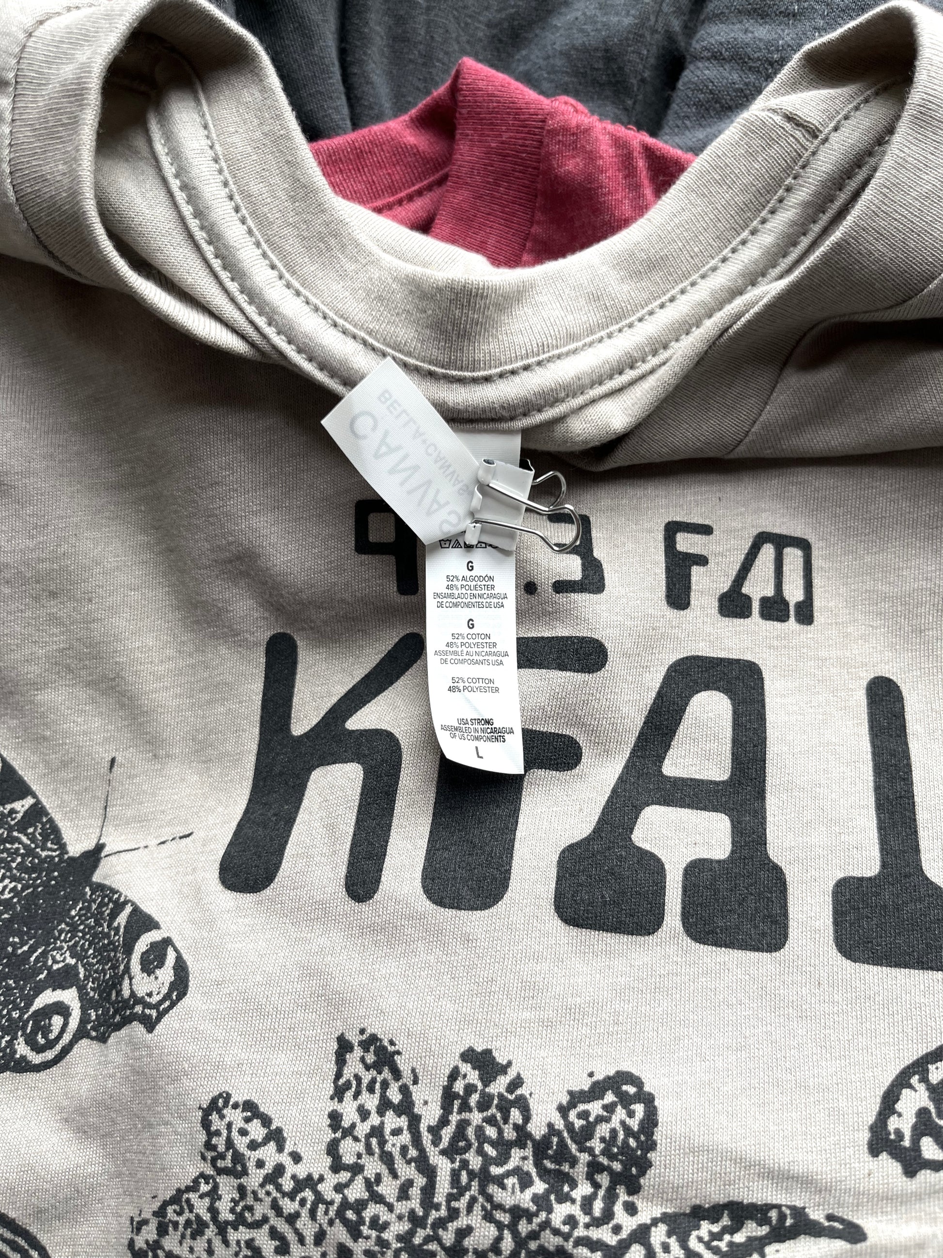 Photo of the garment tag: 52% Airlume combed and ring-spun cotton, 48% polyester, 32 singles, 4.2 oz